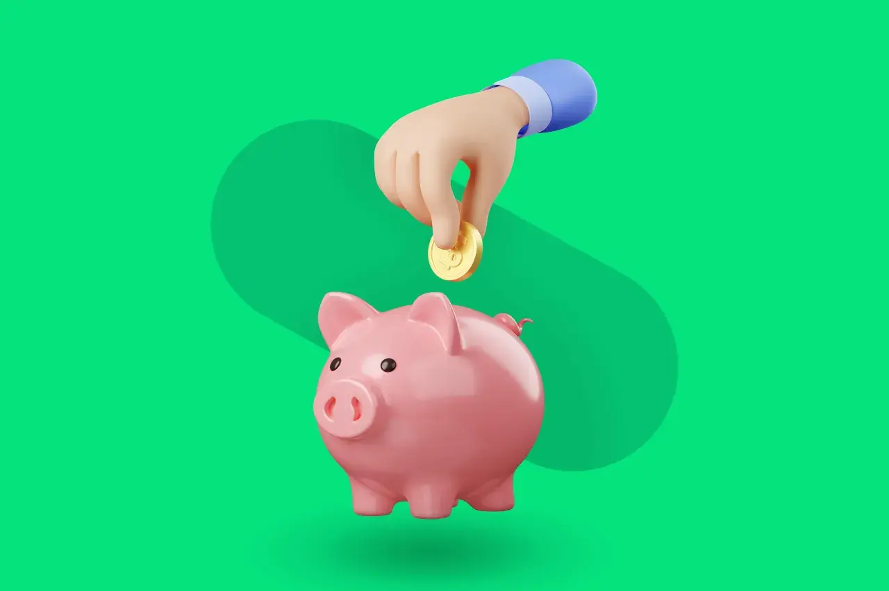 Różowa świnka skarbonka, do której ręka wrzuca monetę. Idealny symbol dla aplikacji do oszczędzania pieniędzy.
